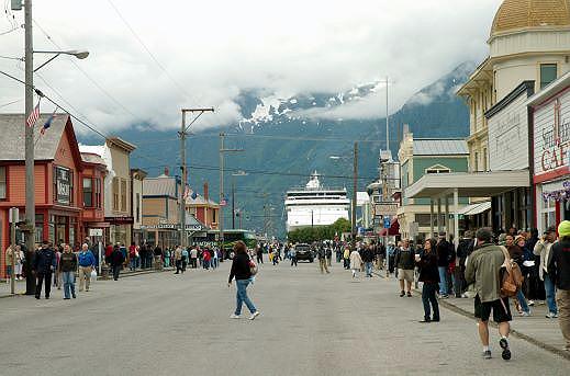 17-skagway_main_thoroughfare_and_cruise_ship.jpg - Skagway, gateway to the Yukon, is part of the Klondike Gold Rush National Historic Park.  In 1897 boatloads of Gold Rush stampeders arrived to seek their fortunes in the Yukon.  Today, it is boatloads of tourists looking to experience a little of that wild and wooly time.